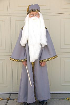 a man dressed as an old wizard standing in front of a garage door