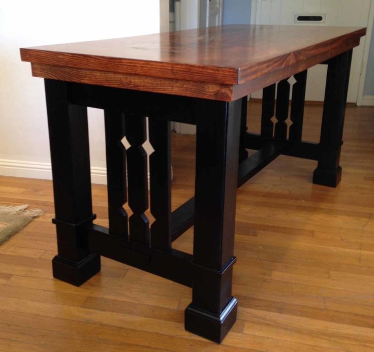 a wooden table sitting on top of a hard wood floor