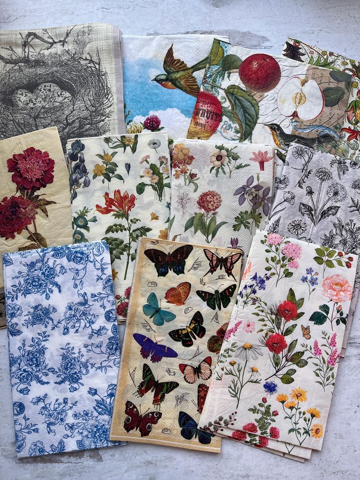 many different types of napkins with flowers and butterflies on them