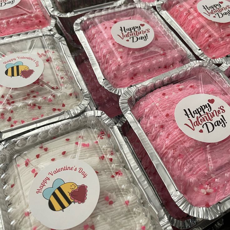 valentine's day desserts are displayed in plastic trays