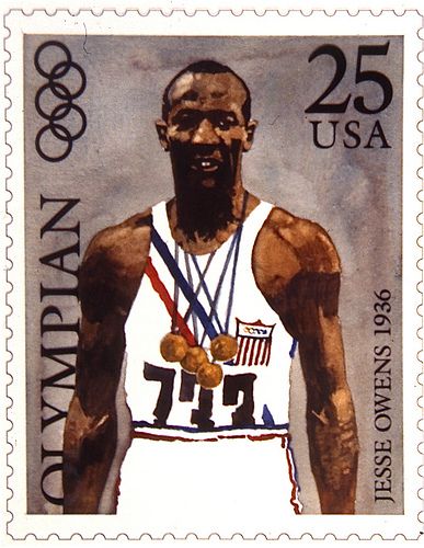 a postage stamp with an image of a basketball player holding two gold medals in his hands