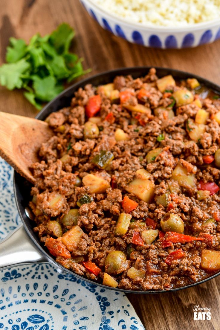 a skillet filled with ground beef and vegetables