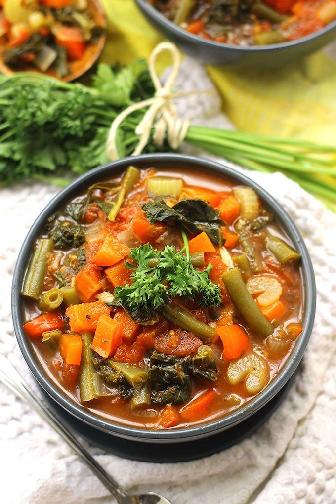 two bowls filled with vegetable soup on top of a table