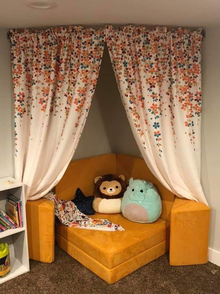 an orange couch with two stuffed animals on it