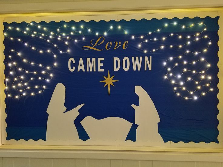 a lighted nativity scene with the words love came down