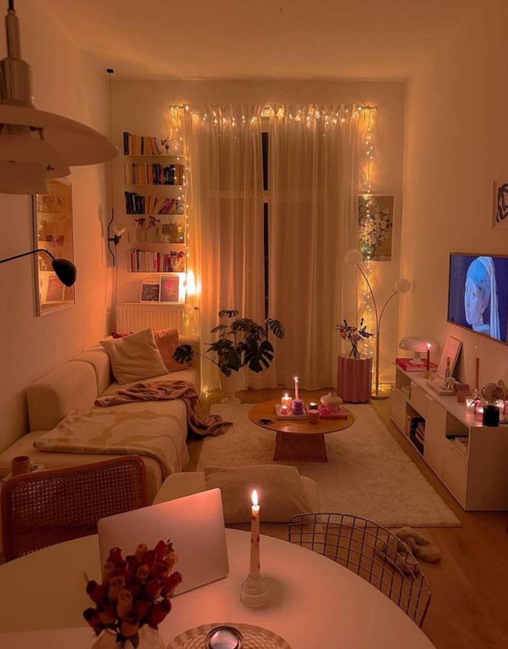 a living room filled with furniture and a flat screen tv sitting on top of a wooden table