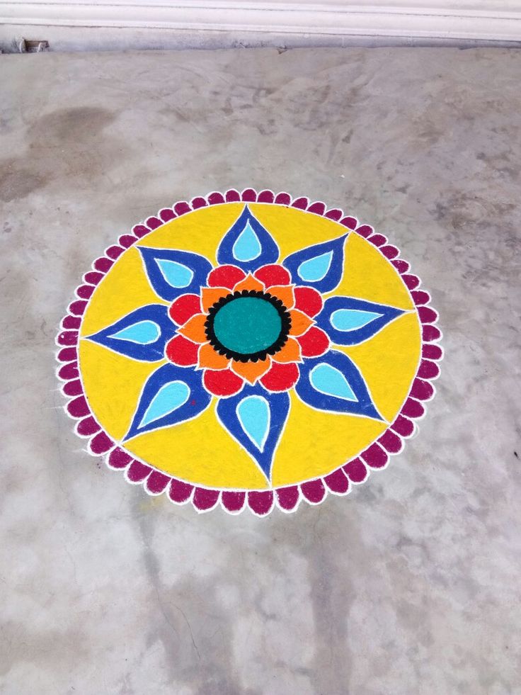 a yellow and blue flower design on the floor in front of a white door frame