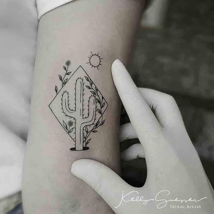 a cactus and diamond tattoo on the left side of the right arm by kaboo designs