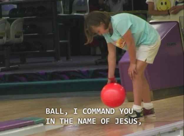 a woman bending over to pick up a red bowling ball with the words, i love you in the name of jesus