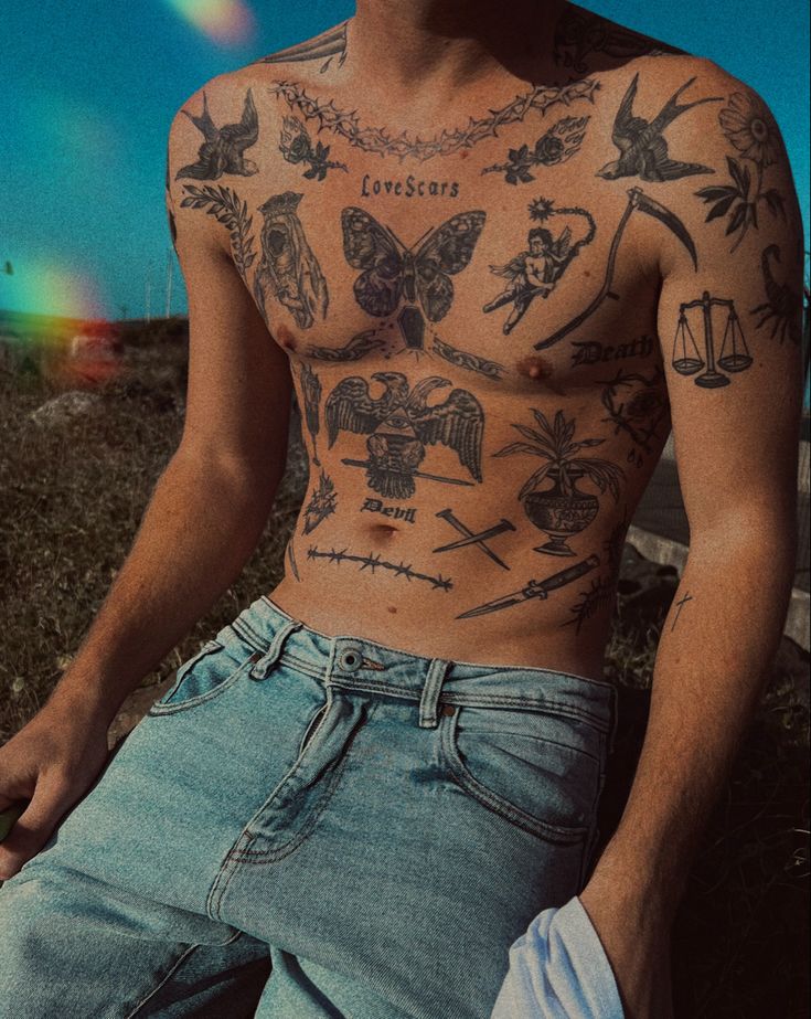 a shirtless man with tattoos on his chest