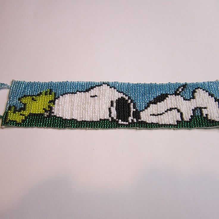 a beaded bracelet with snoopy dogs on it