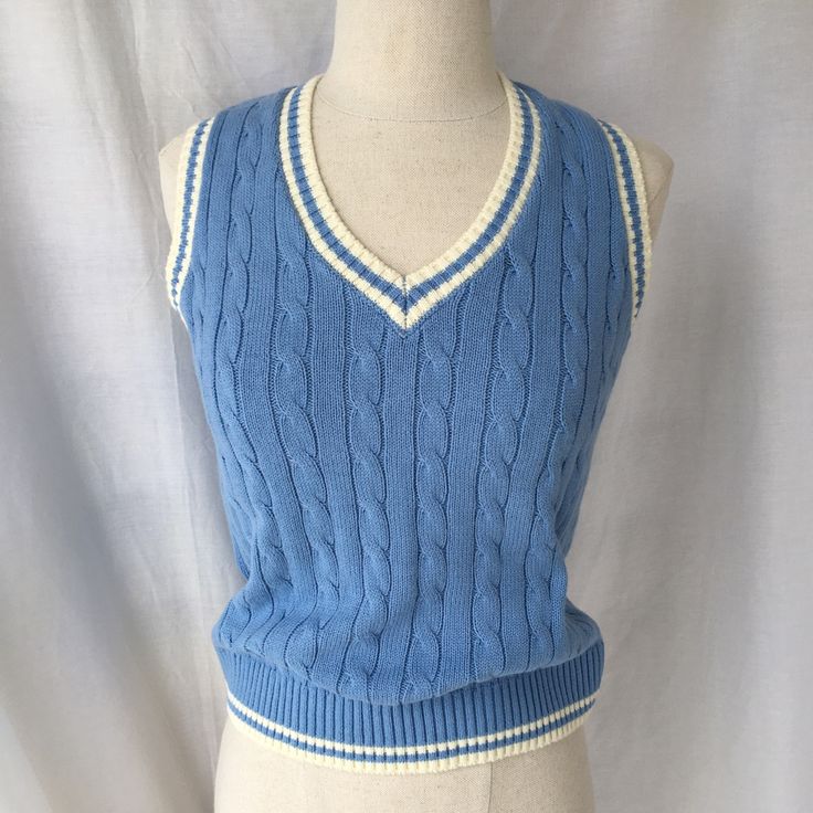 John Galt Blue & White Sweater Vest Nwt Approx. Size Medium Solid Color Vest Cable Knit Stitching Sleeveless V-Neckline Ribbed Trimming Model Measurements: 5’7.5” Height, 32” Bust, 23” Waist, 35” Hip Blue Cotton Sleeveless Sweater Vest, Blue Sleeveless Winter Top, Blue Sleeveless Top For Winter, Blue Fitted Preppy Tops, Blue V-neck Preppy Tops, Preppy Blue V-neck Top, Blue Fitted Sweater Vest For Spring, Fitted Blue Sweater Vest For Spring, Blue Sweater Vest For Summer