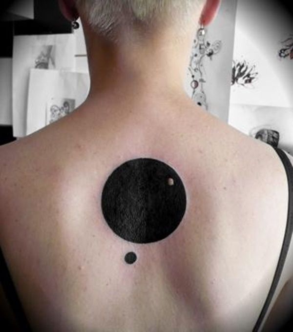 a woman with a black dot on her back