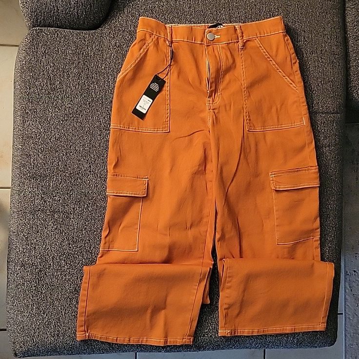 Cargo Pants. High Rise. Color Rust. Looks More Orange In The Picture Than It Actually Is. Has An Elastic Band In The Back On The Waste. Little Stretch. Runs A Little Big. Size:9 Never Worn. Excellent Condition. Spring Orange Jeans With Pockets, Orange Jeans For Spring, Trendy Orange Straight Leg Bottoms, Trendy High Rise Orange Bottoms, Relaxed Fit Orange Pants With Pockets, Orange Relaxed Fit Pants With Pockets, Casual Mid-rise Orange Bottoms, Casual Orange Straight Leg Pants, Orange Relaxed Fit Straight Leg Bottoms