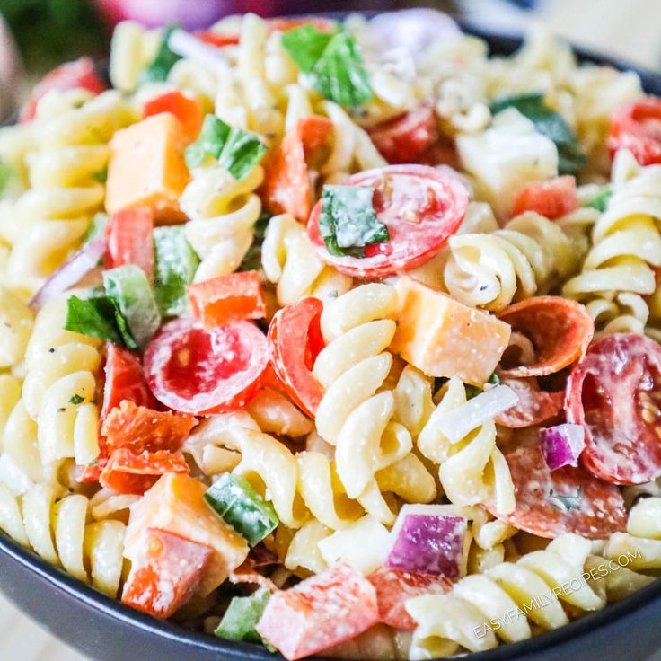 a bowl filled with pasta salad on top of a table