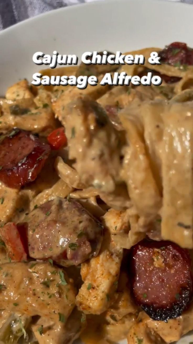 a white plate topped with pasta and sausage covered in gravy