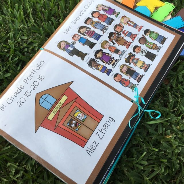 an open book on the grass with pictures of children in it and some colored magnets