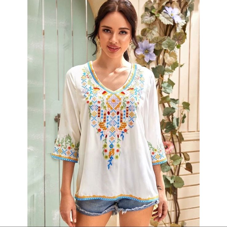 Boho Style Embroidered Tribal Tunic Style Blouse. Three Quarter Sleeve Length, Regular Sleeve, V Neck, Pullover Style, Regular Fit, Non-Stretch. Is Lined One Side Upto High Waist. 97% Rayon, 3% Polyester Perfect For Spring/ Summer Multicolor V-neck Top With Floral Embroidery, Summer V-neck Blouse With Floral Embroidery, Casual V-neck Embroidered Top With Multicolor Embroidery, Casual V-neck Blouse With Geometric Embroidery, V-neck Tops With Floral Embroidery For Vacation, V-neck Blouse With Multicolor Embroidery For Vacation, Summer Long Sleeve Top With Floral Embroidery, Bohemian Multicolor Embroidered V-neck Top, Casual V-neck Top With Multicolor Embroidery