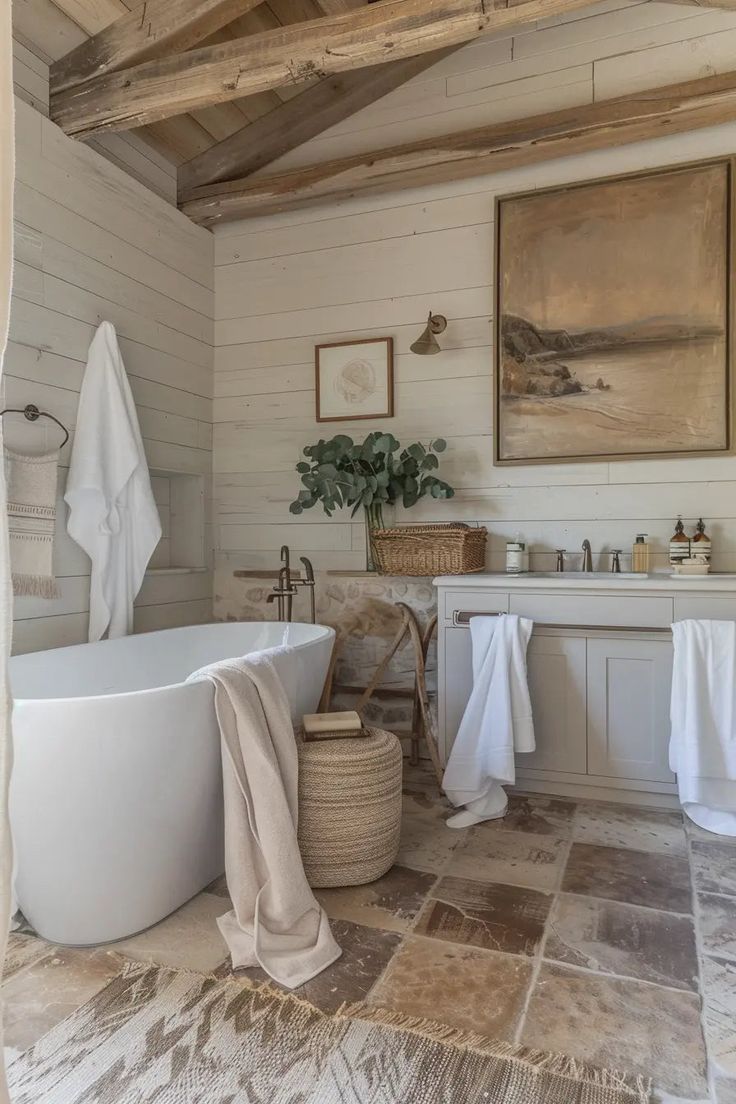 a large white bath tub sitting next to a sink in a bathroom under a wooden ceiling