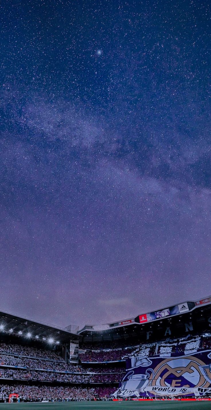 the night sky is filled with stars above a stadium