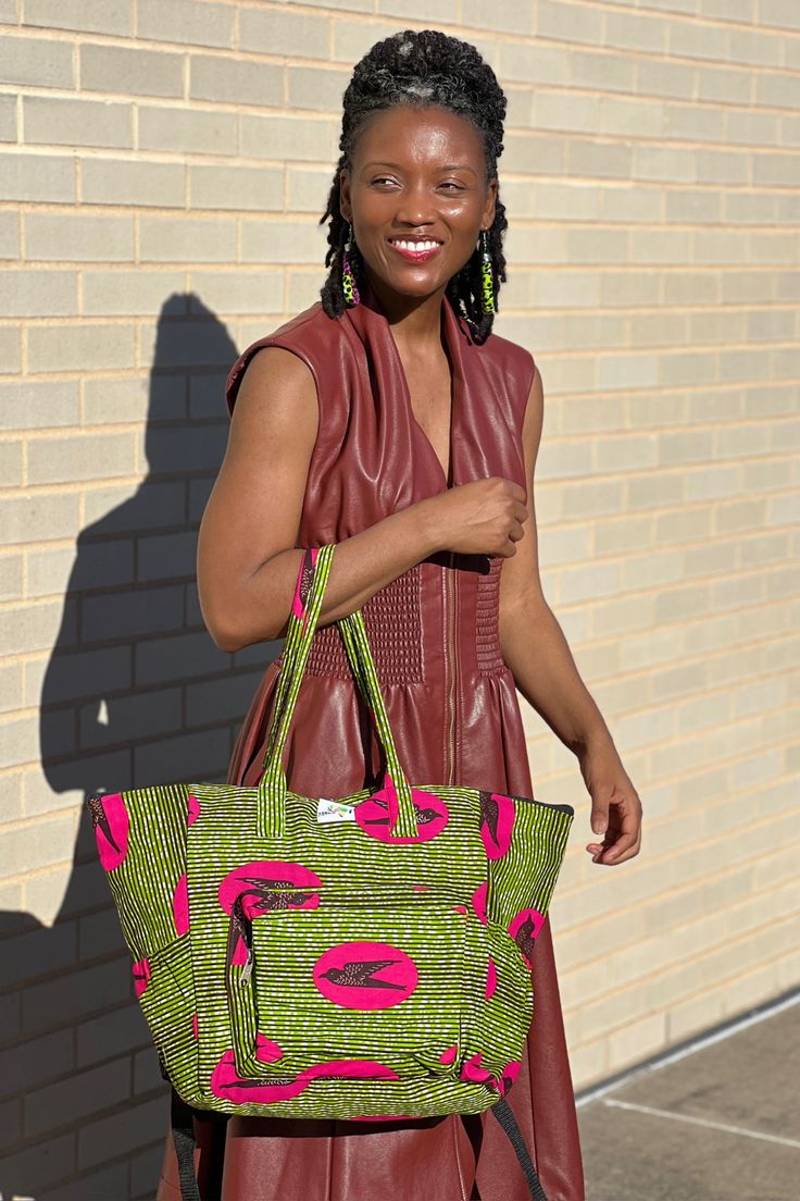 The bag that fits everything and is just everything! The Everything Bag fits all of your essentials stylishly. Handmade in Ghana from authentic Ankara. Disclaimer: Product color and quality seen may vary slightly compared to actual items due to photography lighting conditions and items being one-of-a-kind and cut from different parts of the fabric. Green Tote Weekender Bag For On-the-go, Green Handheld Travel Bag, Casual Green Travel Bag With Removable Pouch, Green Travel Shoulder Bag With Adjustable Strap, Large Shoulder Bag For Travel, Green Double Handle Travel Bag For On-the-go, Green Tote Weekender Bag, Green Tote Bag With Zipper Pocket, Green Tote Bags With Zipper Pocket