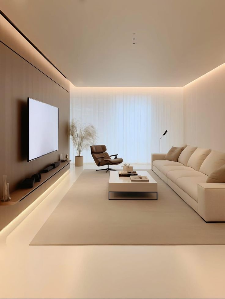 a modern living room with white couches and a flat screen tv on the wall