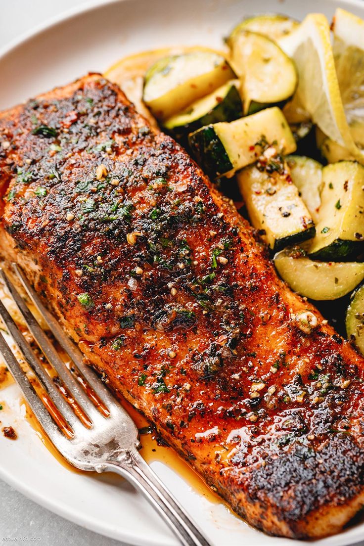 grilled salmon and potatoes on a plate with a fork