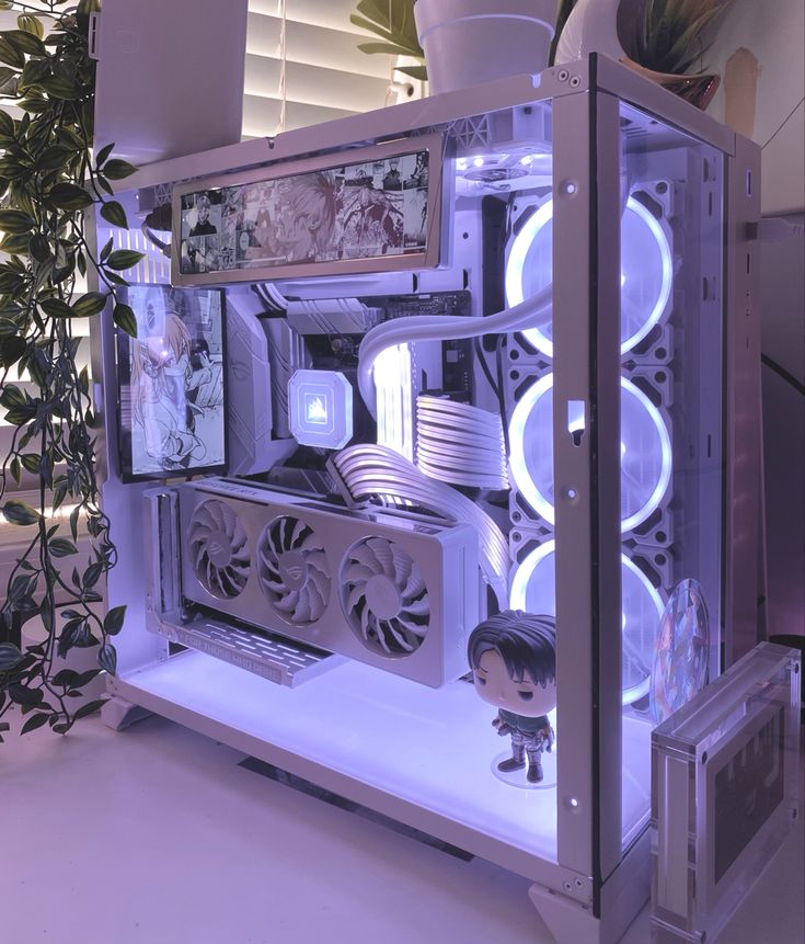 a white computer case sitting on top of a table next to a potted plant