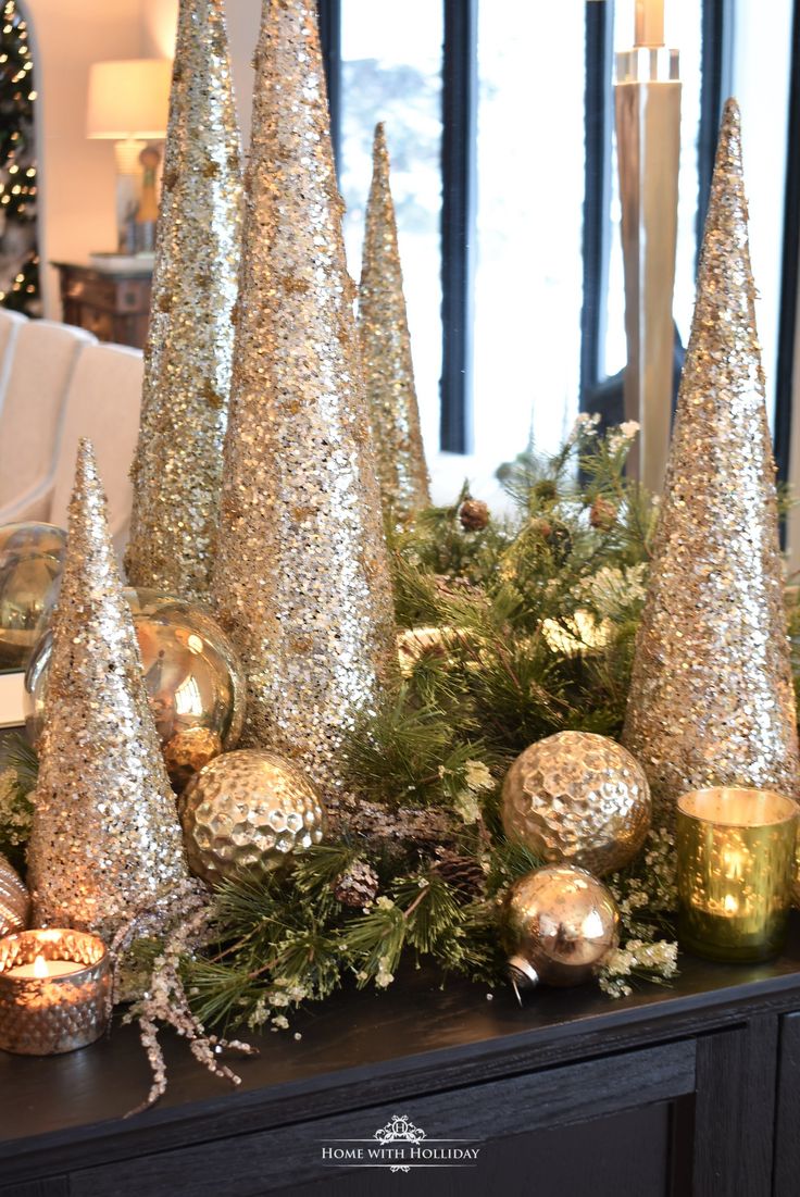 gold and silver christmas decorations on a mantle