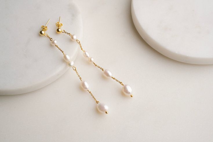 Dazzle on Your Big Day with Our Long Pearl Stud Earrings! Say hello to your perfect wedding accessory! These stunning long pearl stud earrings are 2.5" of pure elegance, designed to make you shine. Handcrafted with love, they come in either sterling silver or stainless steel, available in both gold and silver tones.  Why You'll Love Them: 🍋 Elegant Length: At 2.5" long, these earrings are designed to turn heads. 🍋 Versatile Materials: Choose from sterling silver or stainless steel in gold or s Real Pearl Earrings, Freshwater Pearl Earrings, Pearl Dangle Earrings, Pure Elegance, Wedding Accessory, Etsy Bridesmaid Gifts, Freshwater Pearls Earrings, Jewelry Statement, Earrings Pearl