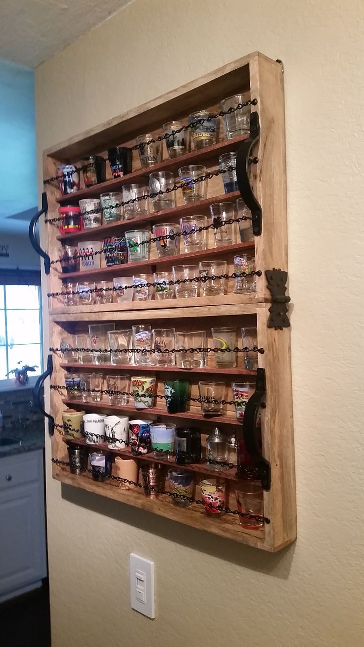 a wall mounted spice rack filled with lots of spices