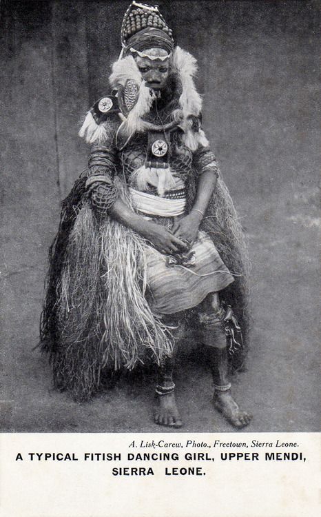 an old black and white photo of a person dressed in native american clothing with feathers