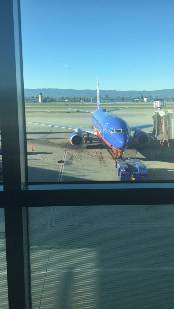 an airplane sitting on the tarmac at an airport