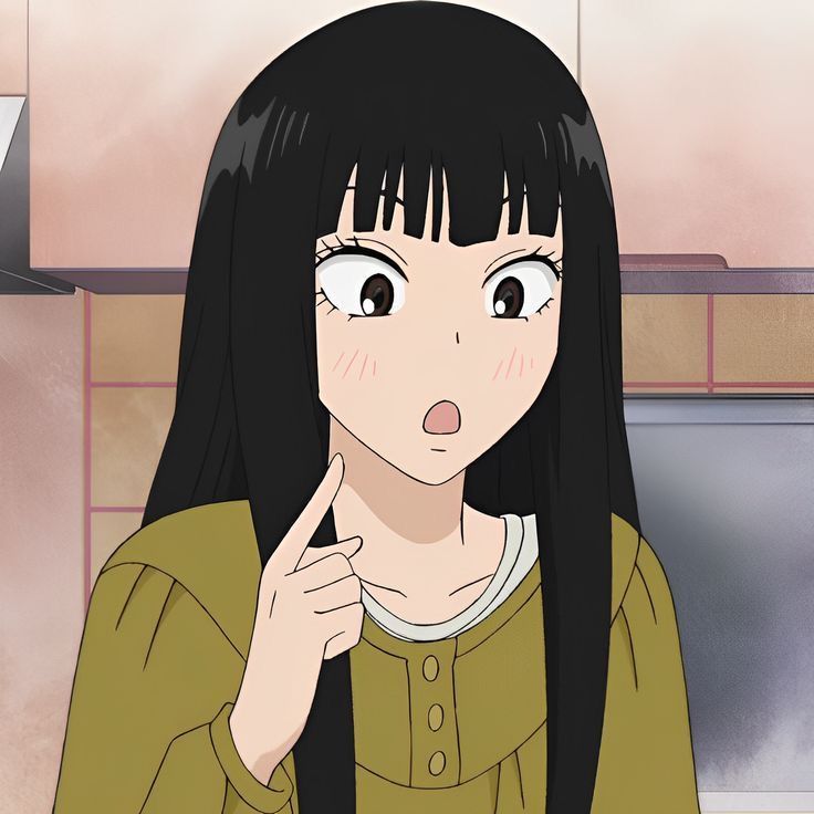 a woman with long black hair standing in front of a stove top oven holding her finger to her mouth