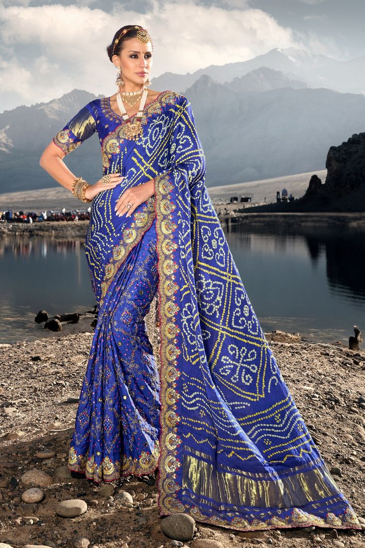 Indulge in the traditional appeal with our Marvelous Satin Pure Gajji Gharchola Bandhani Nakshi Work Saree. It showcases intricate handiwork which highlights the richness of the design. The Saree features heavy embroidery and comes with an ornate blouse. An epitome of Indian culture, perfect for weddings, and festivals Royal Blue Saree, Classic Saree, Mirror Work Saree, Traditional Saree, Bandhani Saree, Blue Saree, Trendy Sarees, Wear Saree, Blouse Material