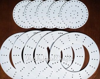 six white polka dot paper plates on a wooden table