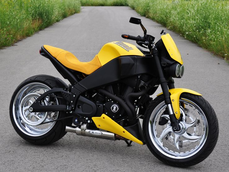 a yellow motorcycle parked on the side of a road