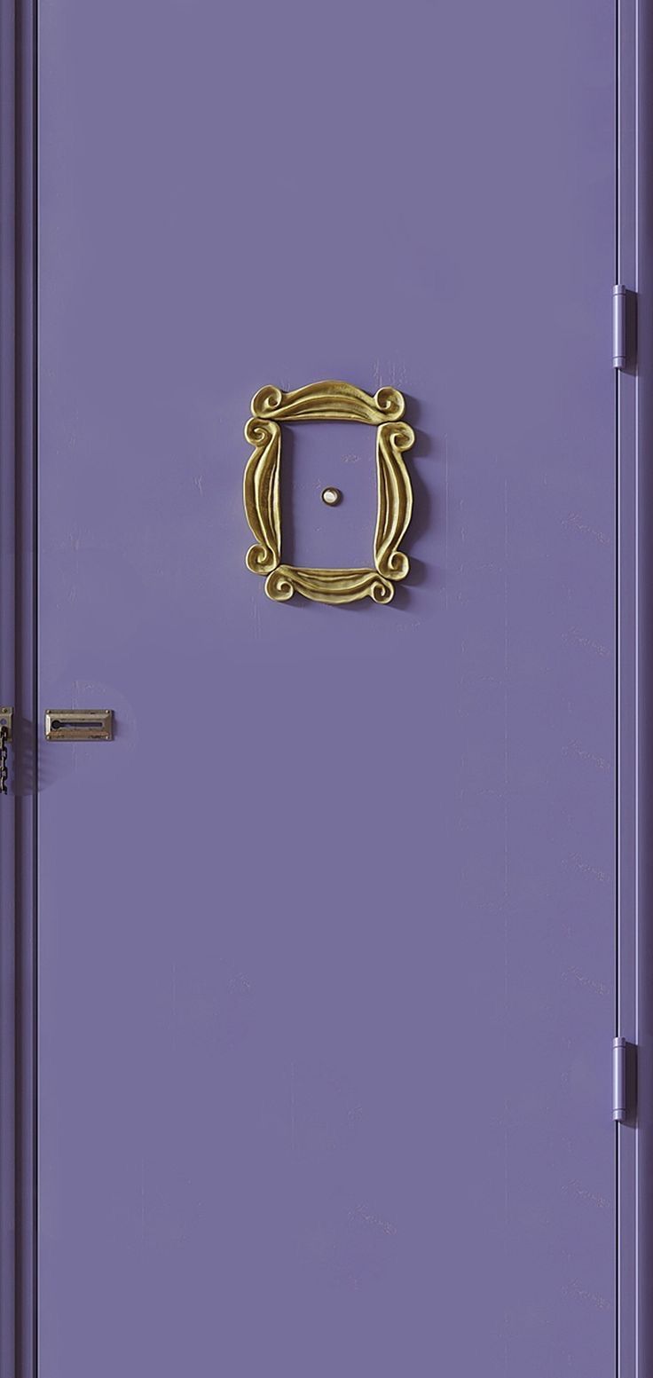 a purple door with a gold handle on it