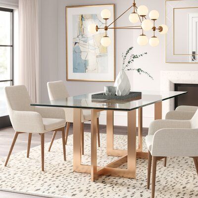 a dining room table with white chairs around it