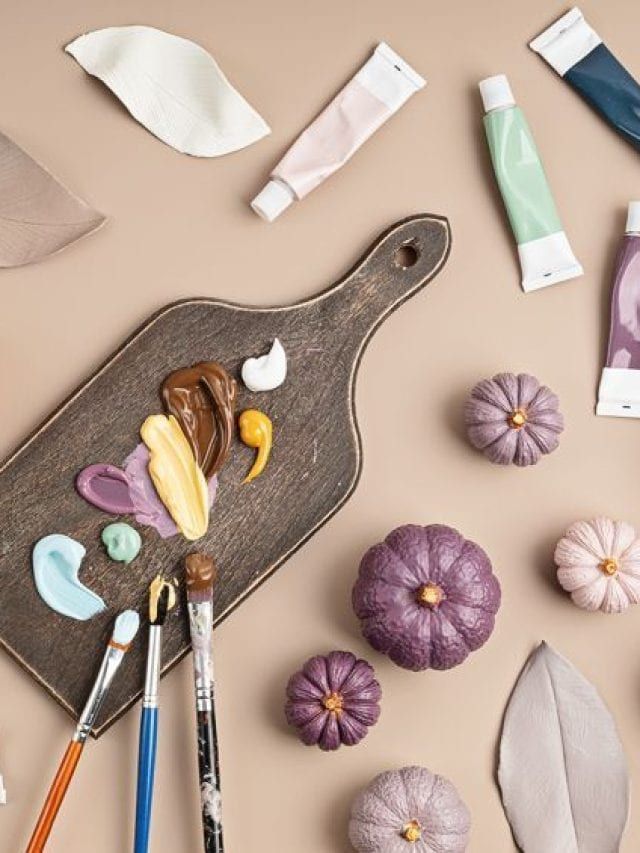 various crafting supplies laid out on top of a wooden tray with scissors and other items