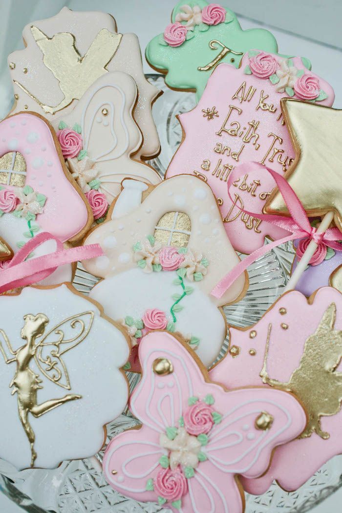 a glass bowl filled with lots of decorated cookies