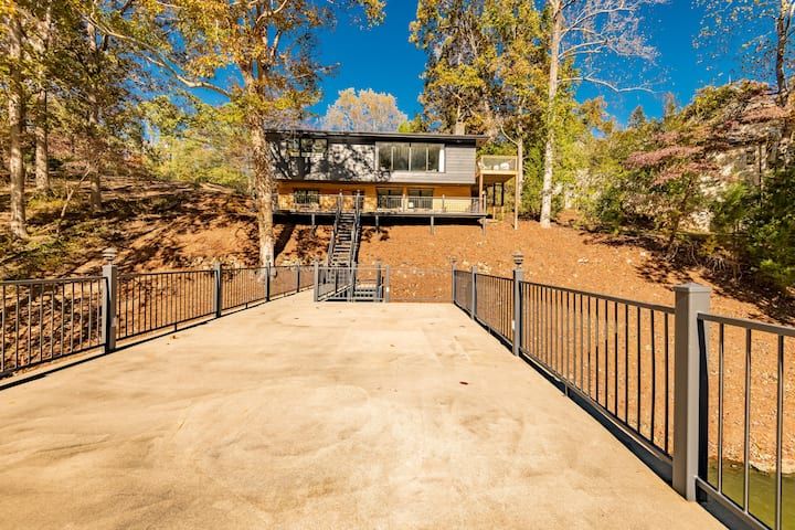 a house in the woods with stairs leading up to it