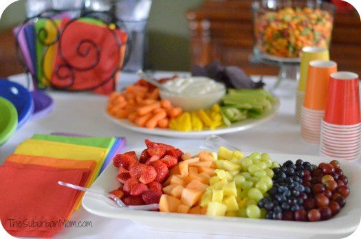 there are many different types of fruit on the table and one is orange, red, green, blue, yellow