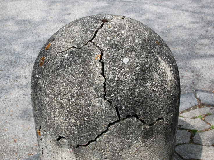 a large rock sitting on top of a sandy beach