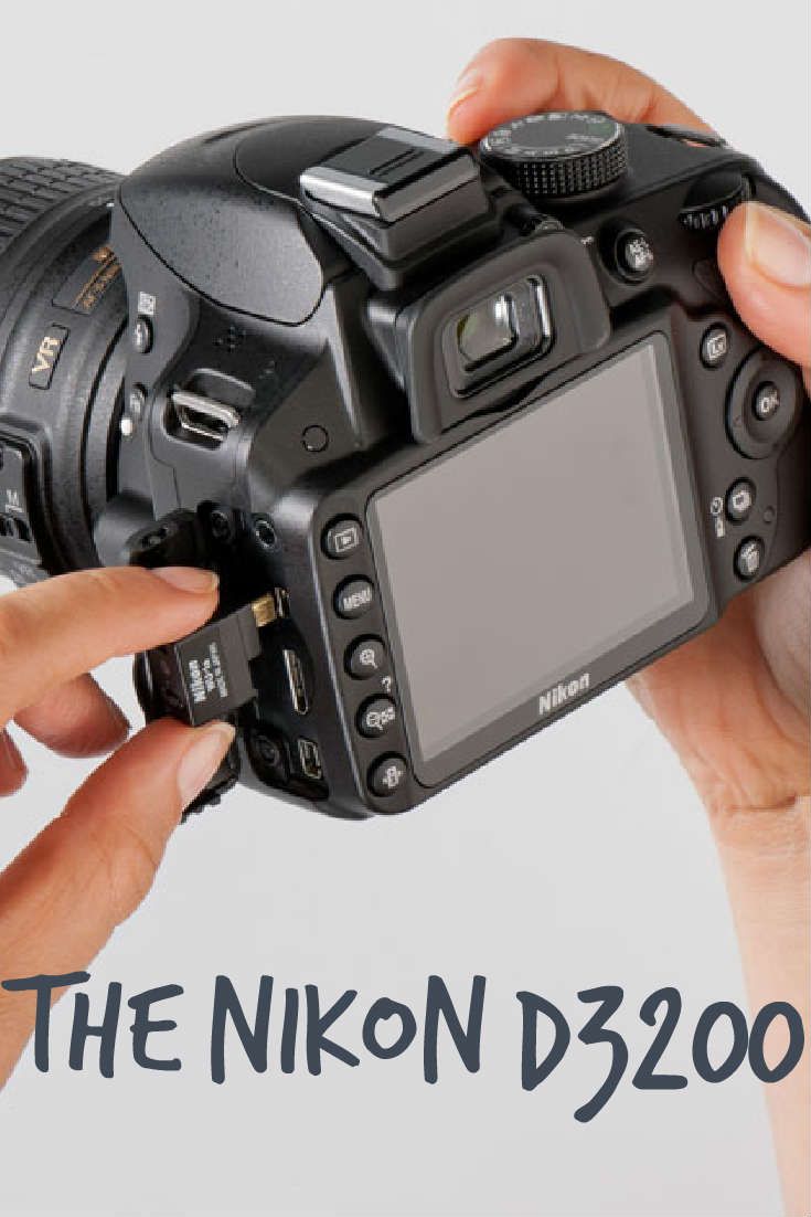 two hands holding up a digital camera with the nikon d320 logo on it