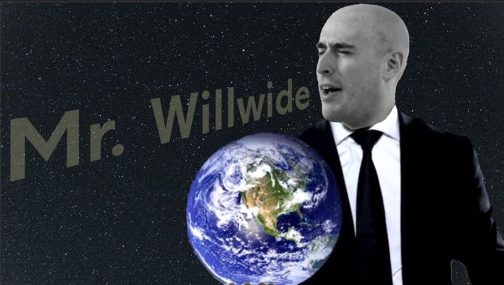 a man in a suit and tie holding up a globe with the words mr willwide on it