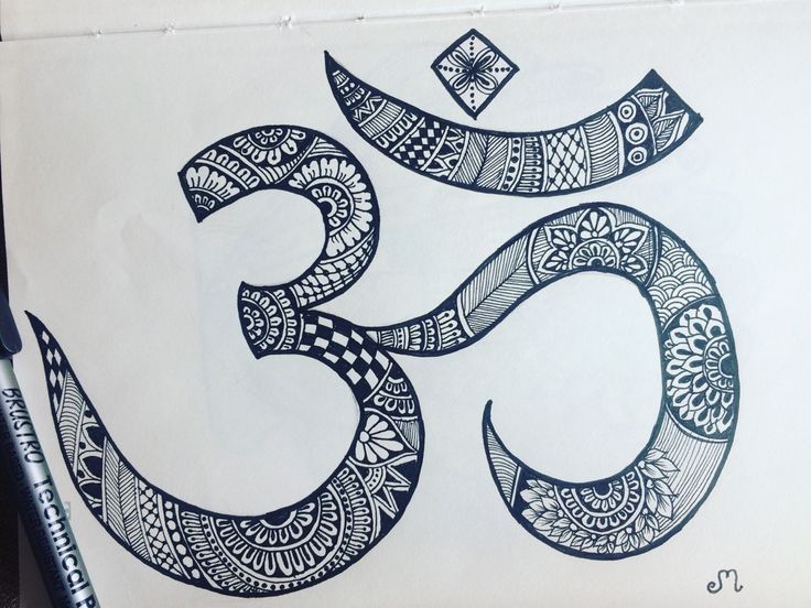 a black and white drawing of an om sign on a piece of paper with markers