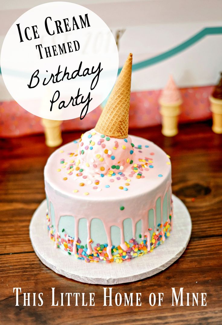 a birthday cake decorated with sprinkles and an ice cream cone on top