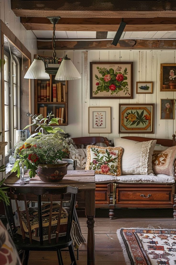 a living room filled with furniture and lots of pictures on the wall next to a window