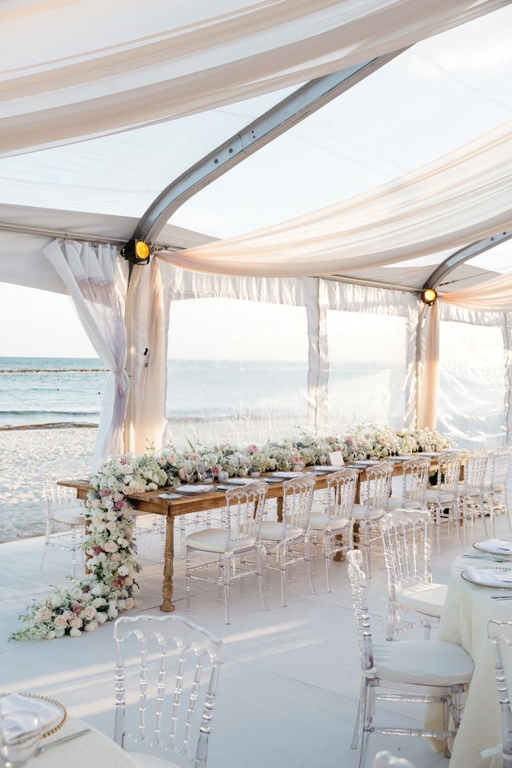 an instagram page with a table and chairs set up for a wedding reception on the beach